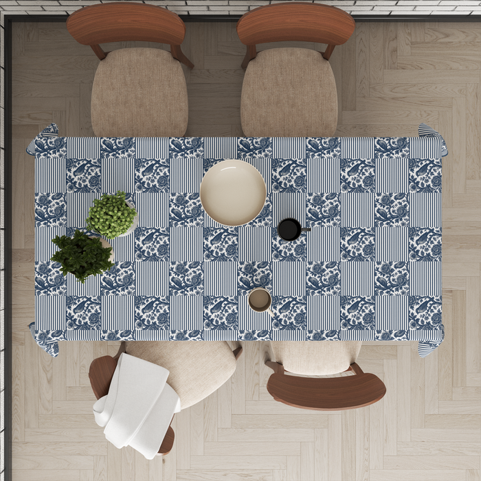 Navy-and-white patchwork print alternating floral and striped blocks, styled with tableware for a dining setting