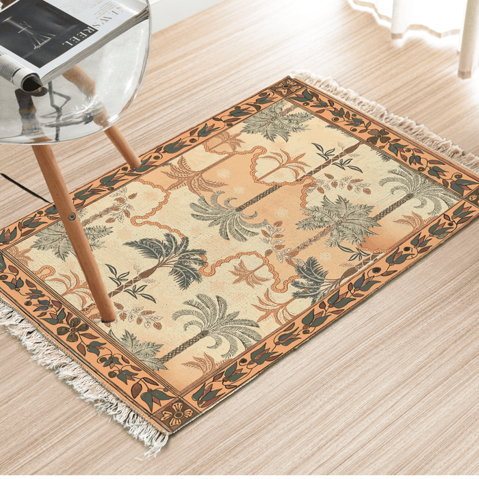 Angled view of the tropical palm tree Dhurrie rug on a light wood floor beside a chair