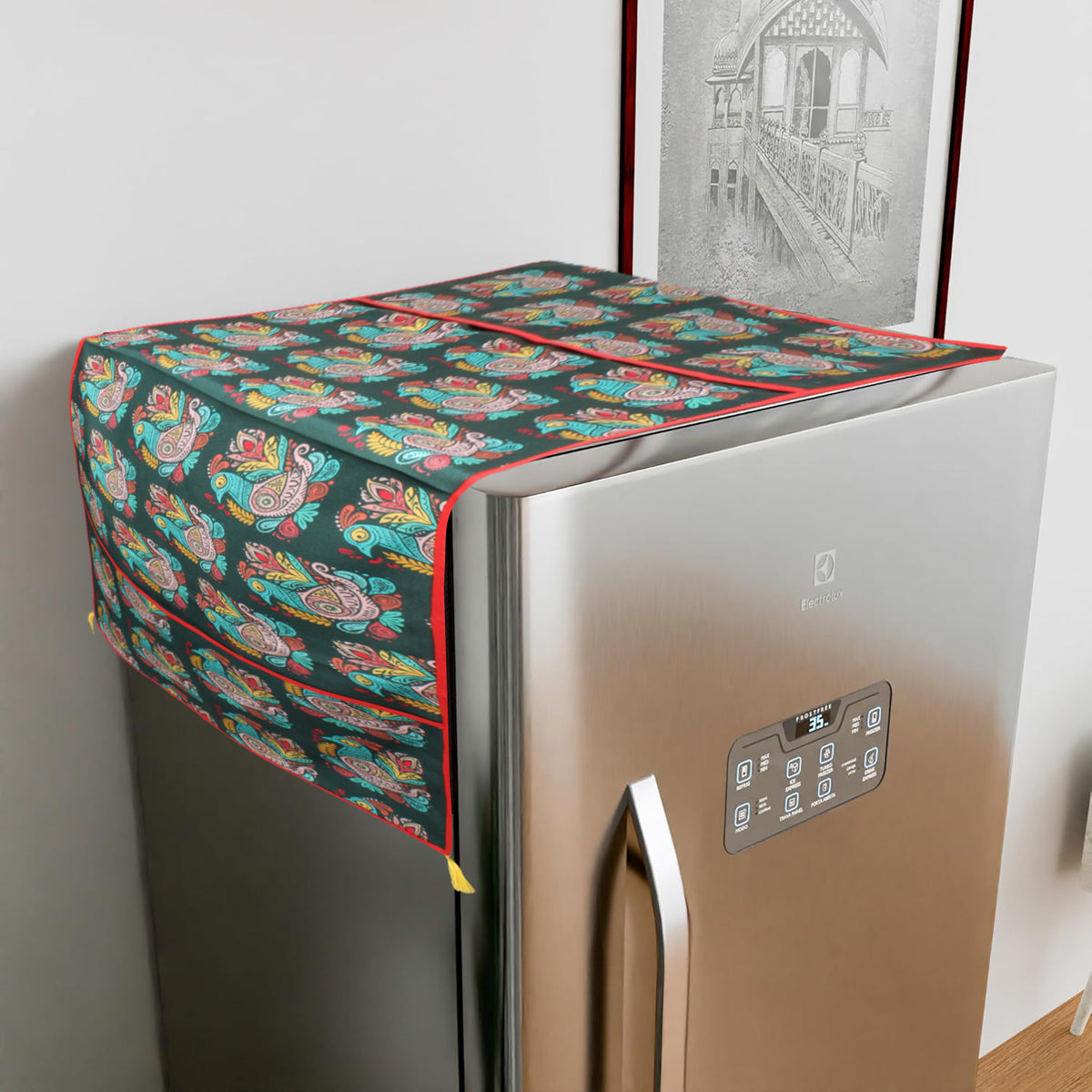 Cotton fridge cover with a colorful peacock-paisley print on a dark teal ground, draped over a refrigerator