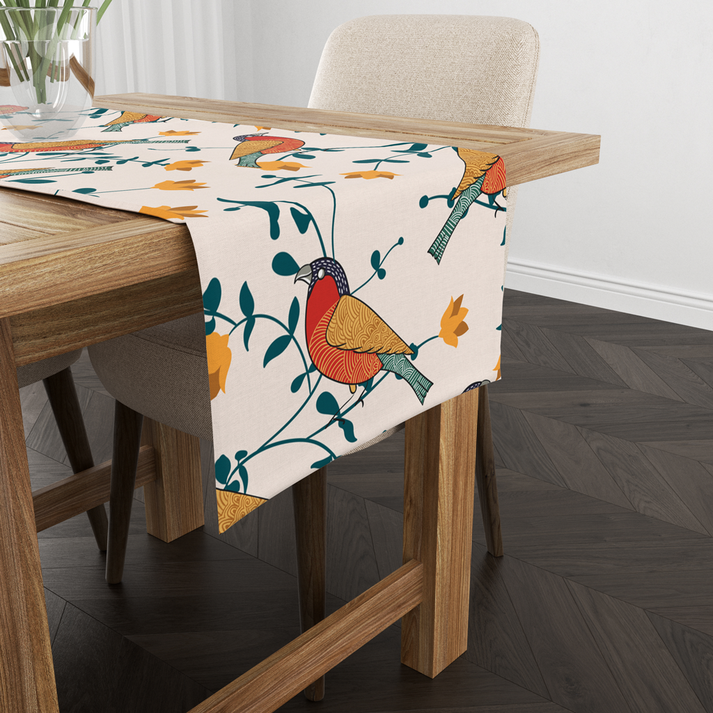Cream bird print table runner draped over a wooden table corner near a chair