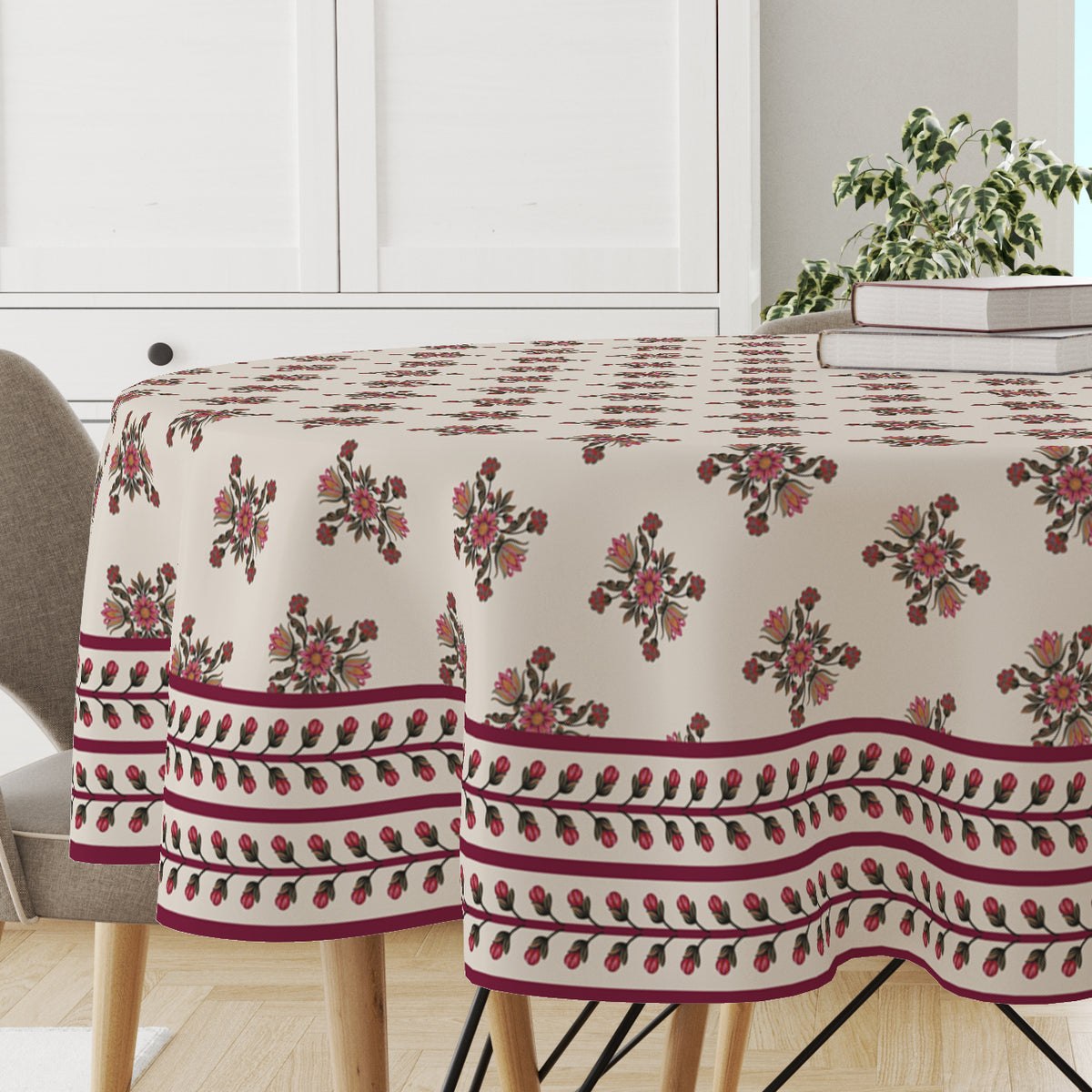 Close-up of the maroon floral block print and border on the round cotton tablecloth