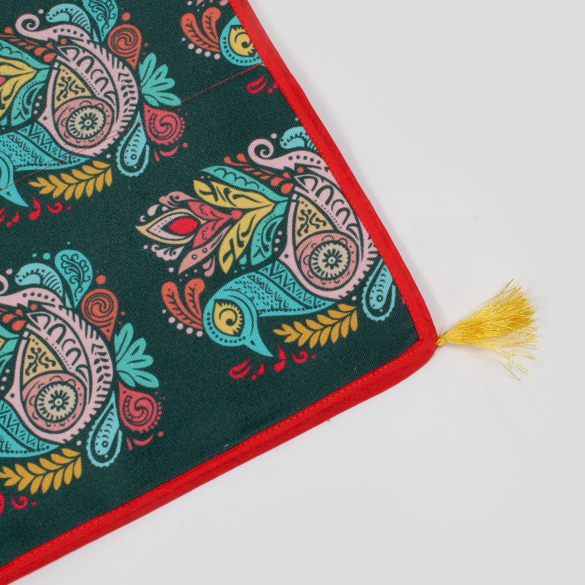 Close-up of the fridge cover's corner showing red trim and a yellow tassel