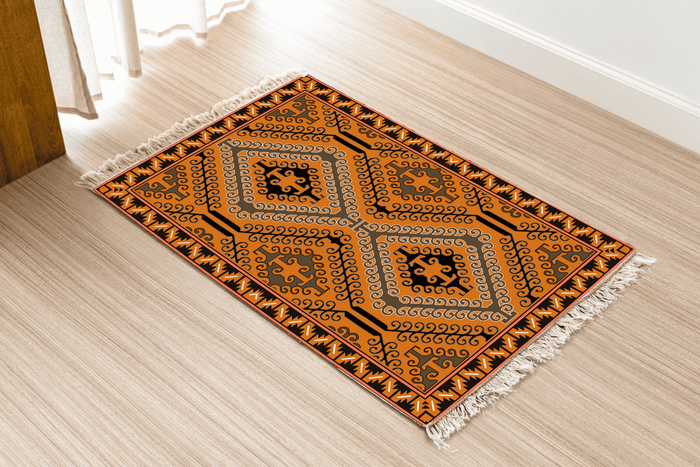 Angled view of the geometric kilim Dhurrie rug on a wood floor near a curtained doorway