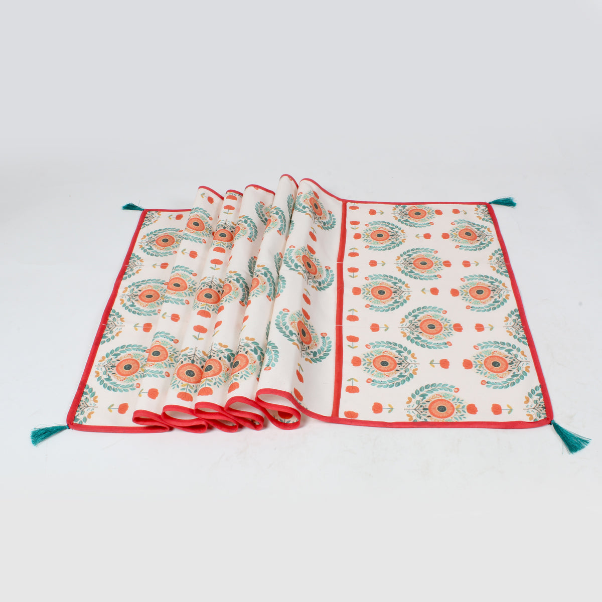Teal and orange medallion print fridge cover shown fully unfolded with red piping and teal tassels