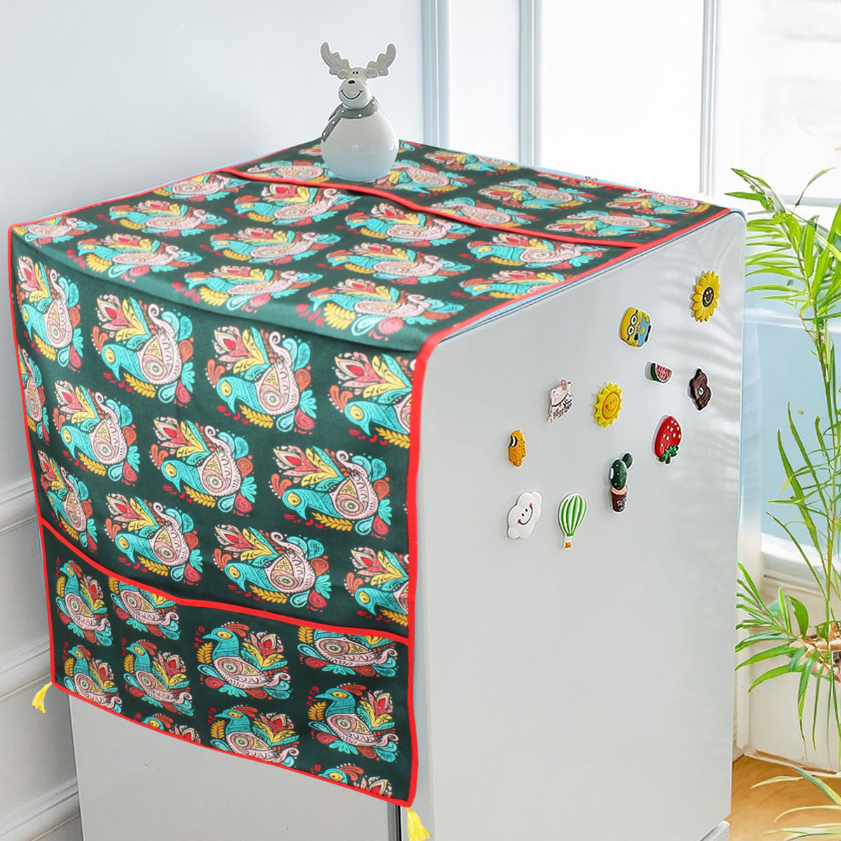 Peacock-paisley print fridge cover draped over a refrigerator decorated with fridge magnets