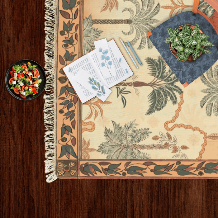 Close-up corner of the tropical palm tree Dhurrie rug styled with a small salad bowl and a potted plant