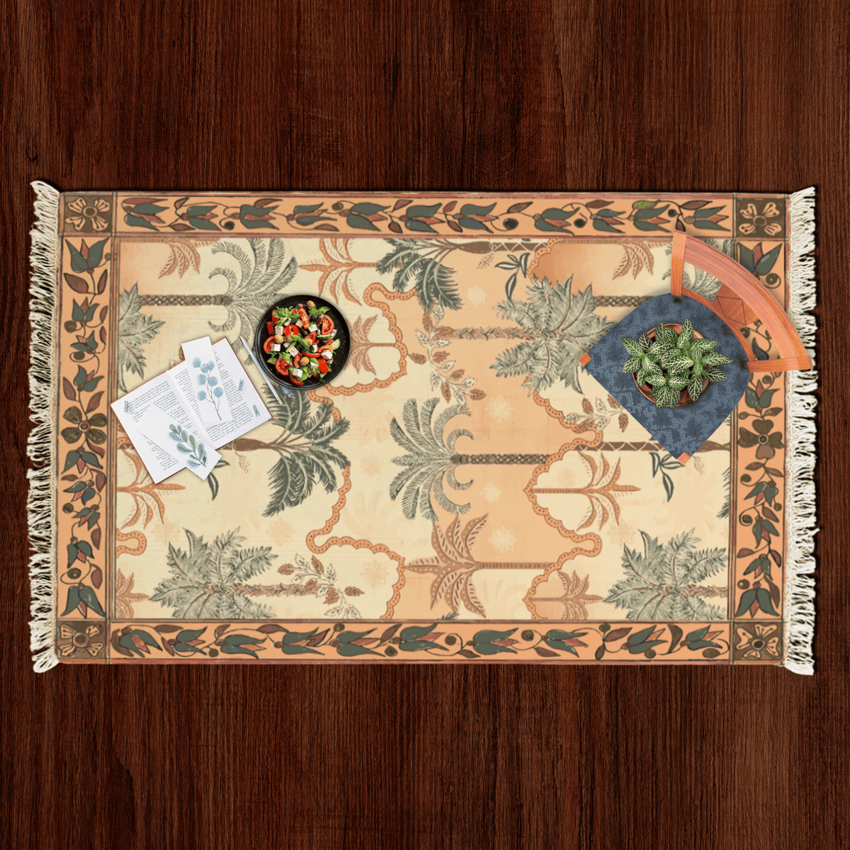 Top-down flat lay of the tropical palm tree Dhurrie rug styled with a salad bowl, notecards, and a potted plant