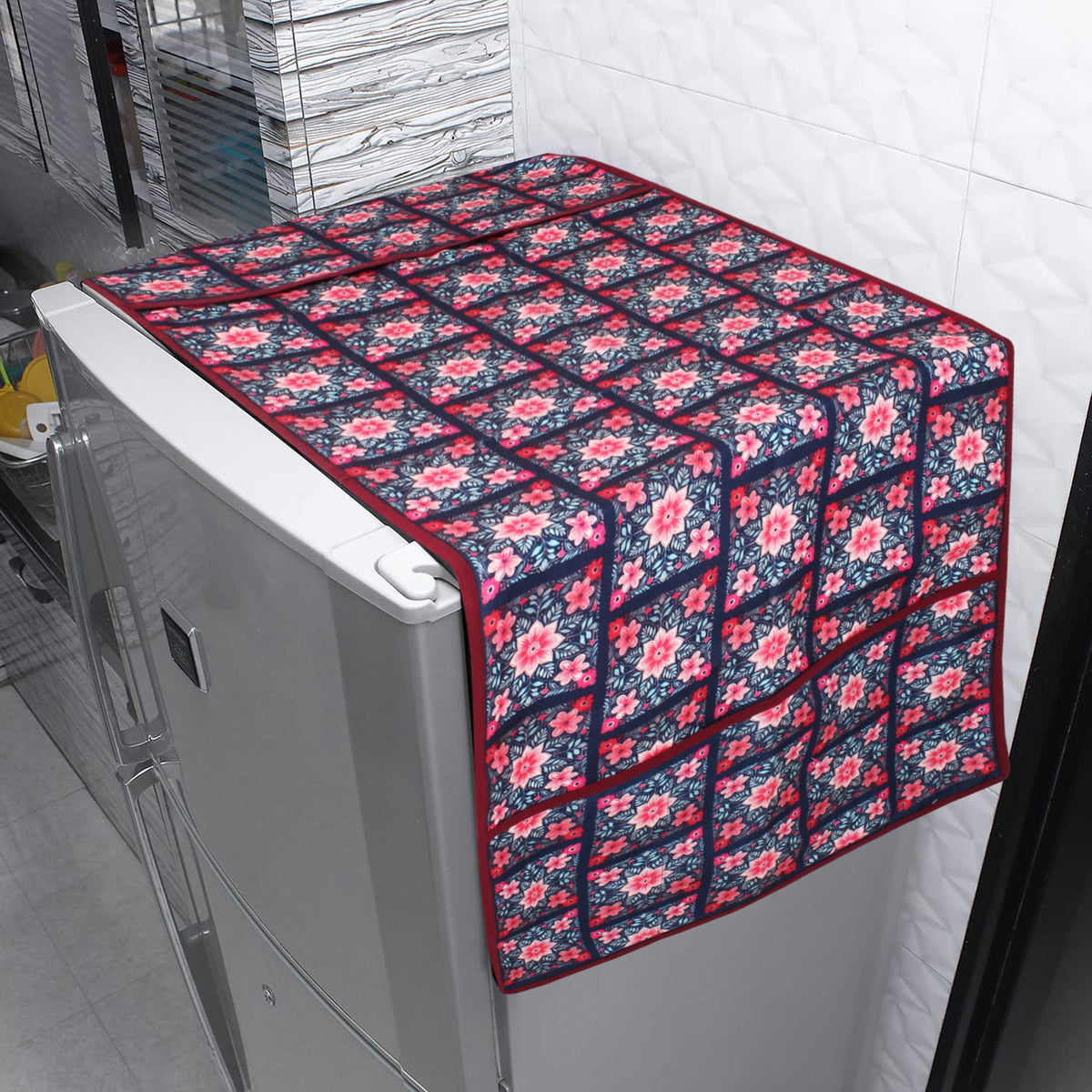 Floral tile print fridge cover draped over a refrigerator in a tiled kitchen