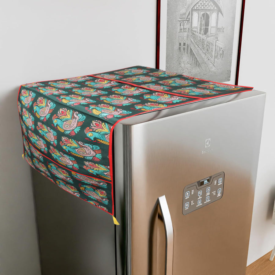 Cotton fridge cover with a colorful peacock-paisley print on a dark teal ground, draped over a refrigerator