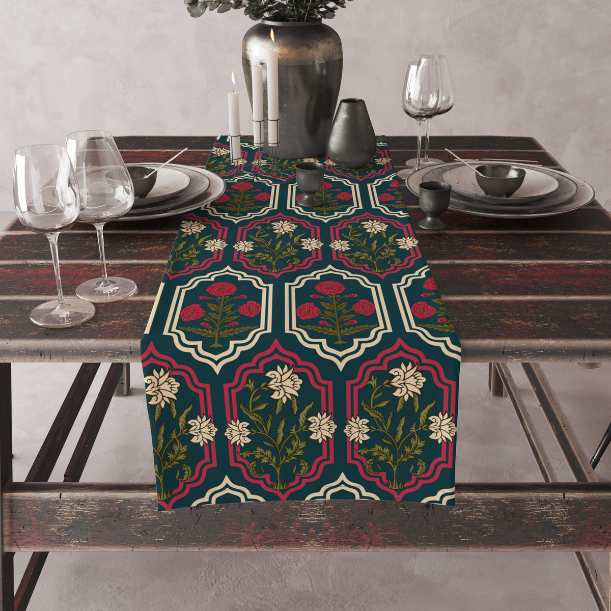 Deep teal table runner with ornate red and cream medallion frames and floral motifs, set on a full dining table with candles