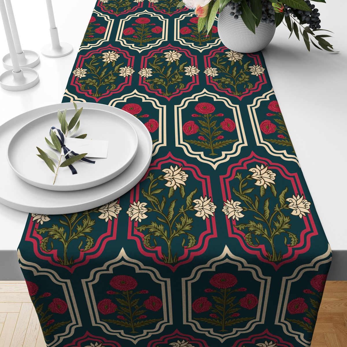Deep teal table runner with ornate red and cream medallion frames and floral motifs, styled on a wooden dining table