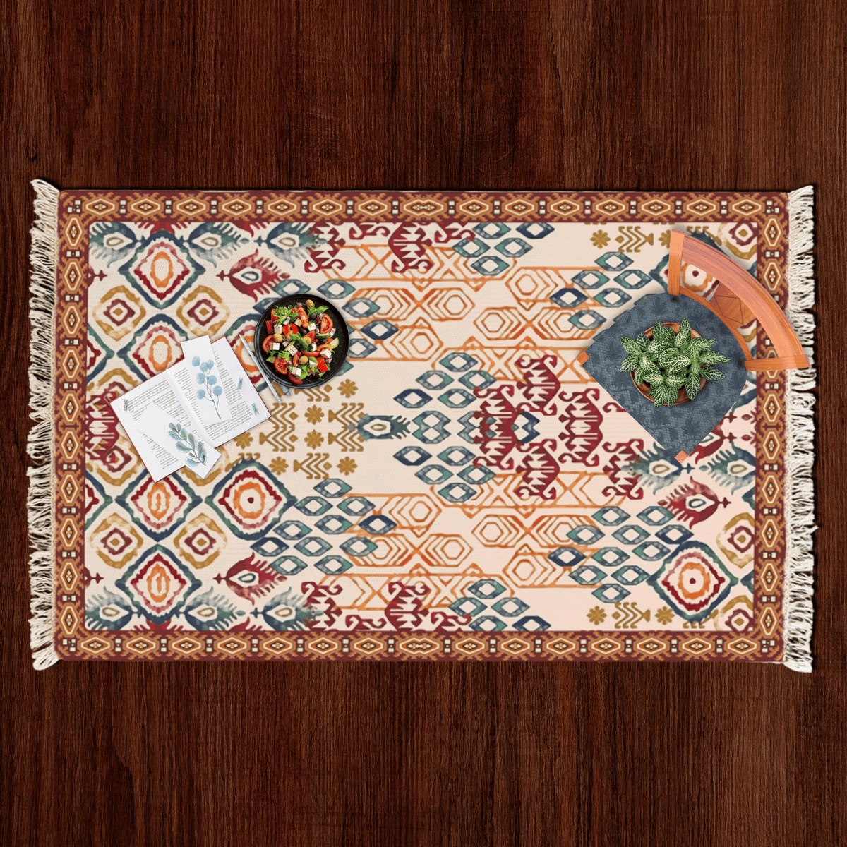 Top-down flat lay of the ikat diamond Dhurrie rug styled with a salad bowl, notecards, and a potted plant
