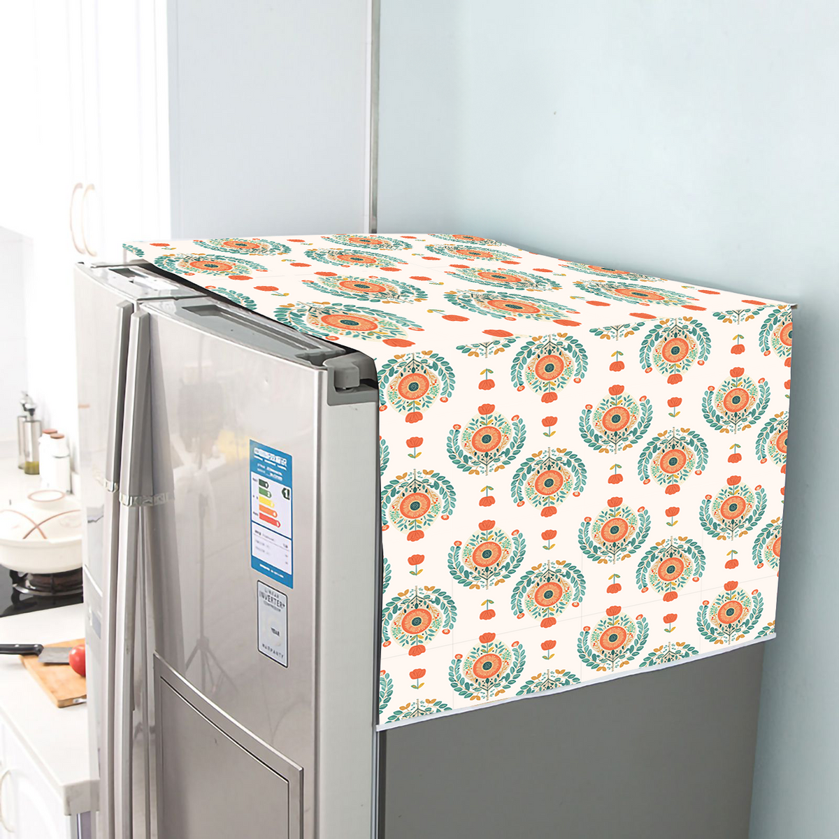 Cotton fridge cover with a teal and orange medallion block print, draped over a refrigerator