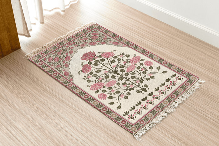 Angled view of the rose bouquet floral medallion Dhurrie rug on a wood floor near a curtained doorway