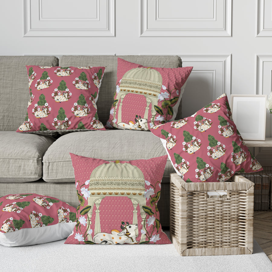 Cushion cover set of 5 with a Pichwai-inspired temple pavilion and cow print in dusty rose, silk poly mix, on a sofa