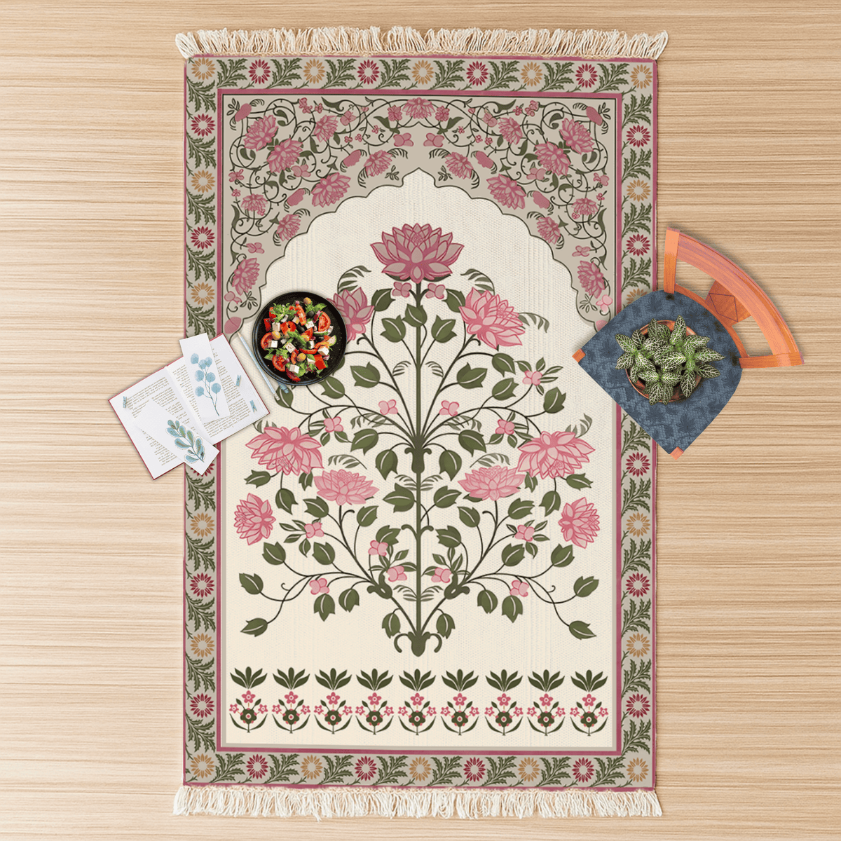 Overhead flat lay of the rose bouquet floral medallion Dhurrie rug with a snack bowl and a small houseplant on top
