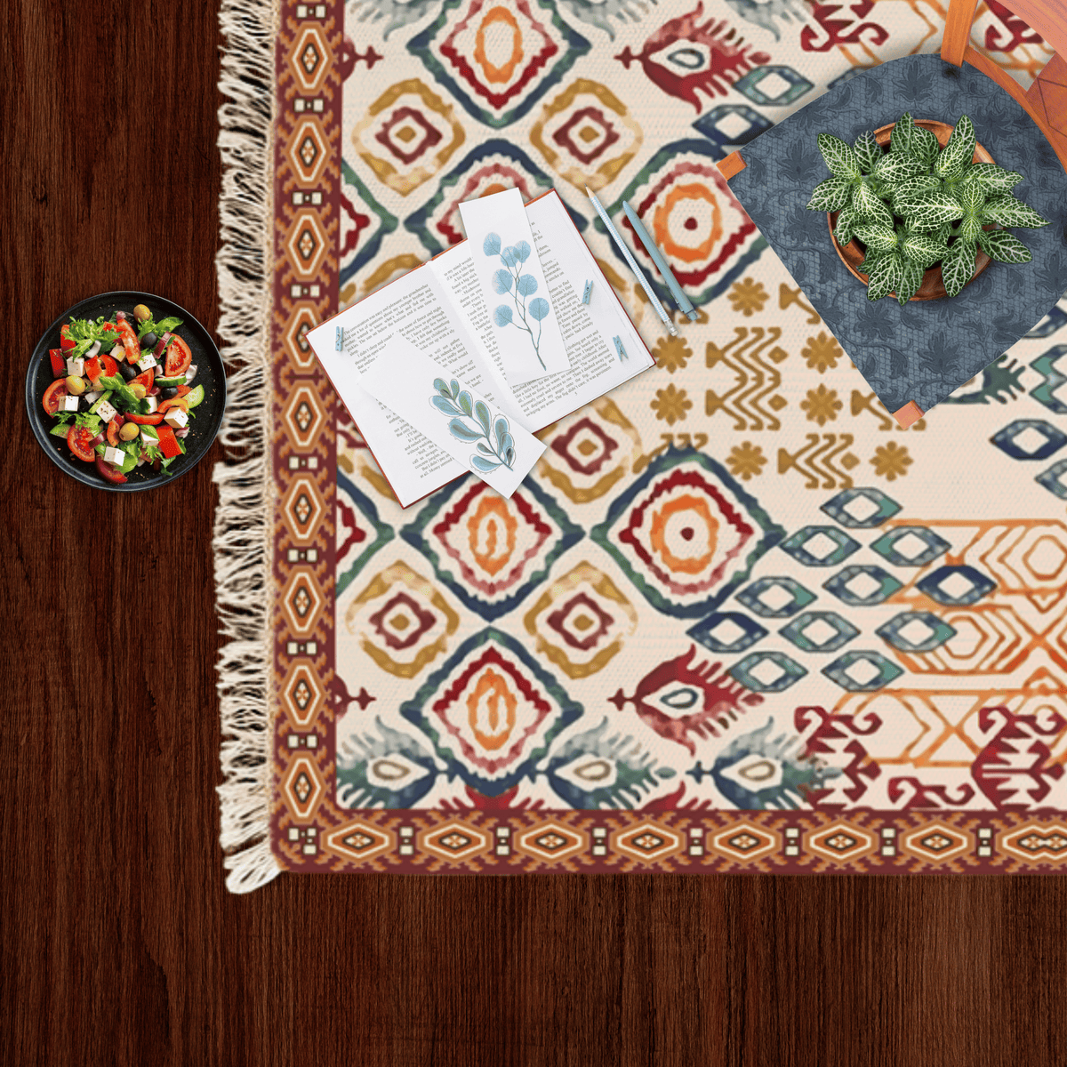 Close-up corner of the ikat diamond Dhurrie rug styled with a small salad bowl and a potted plant