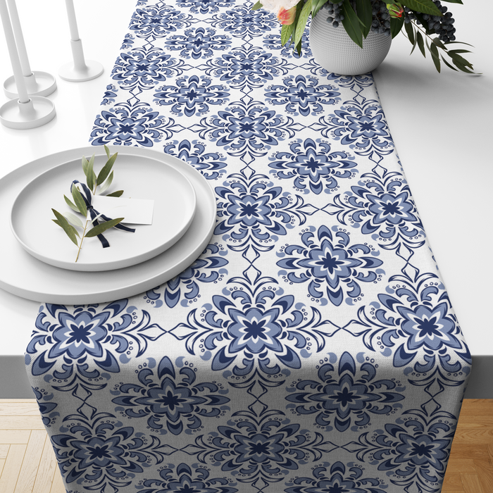 White table runner with a Turkish-tile-inspired indigo medallion print, styled on a wooden dining table