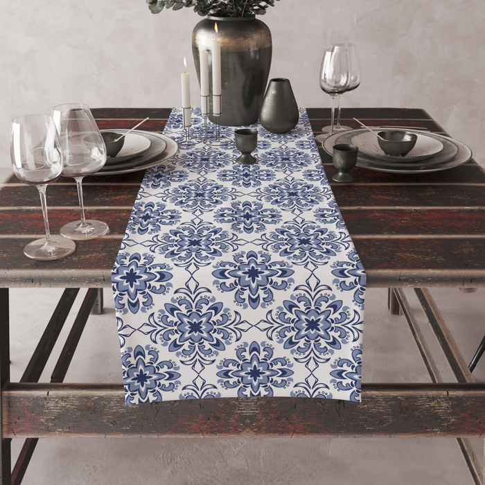 White table runner with a Turkish-tile-inspired indigo medallion print, set on a full dining table with candles