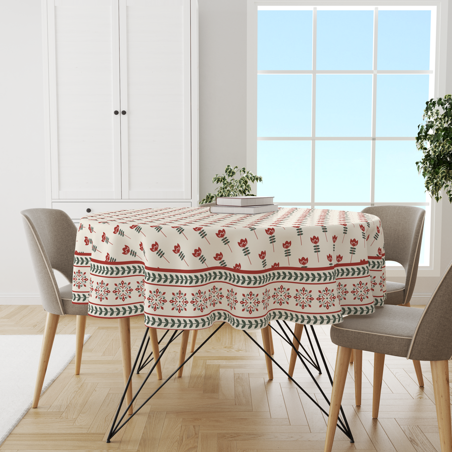 Round cream tablecloth with a red tulip print and floral medallion border, on a dining table