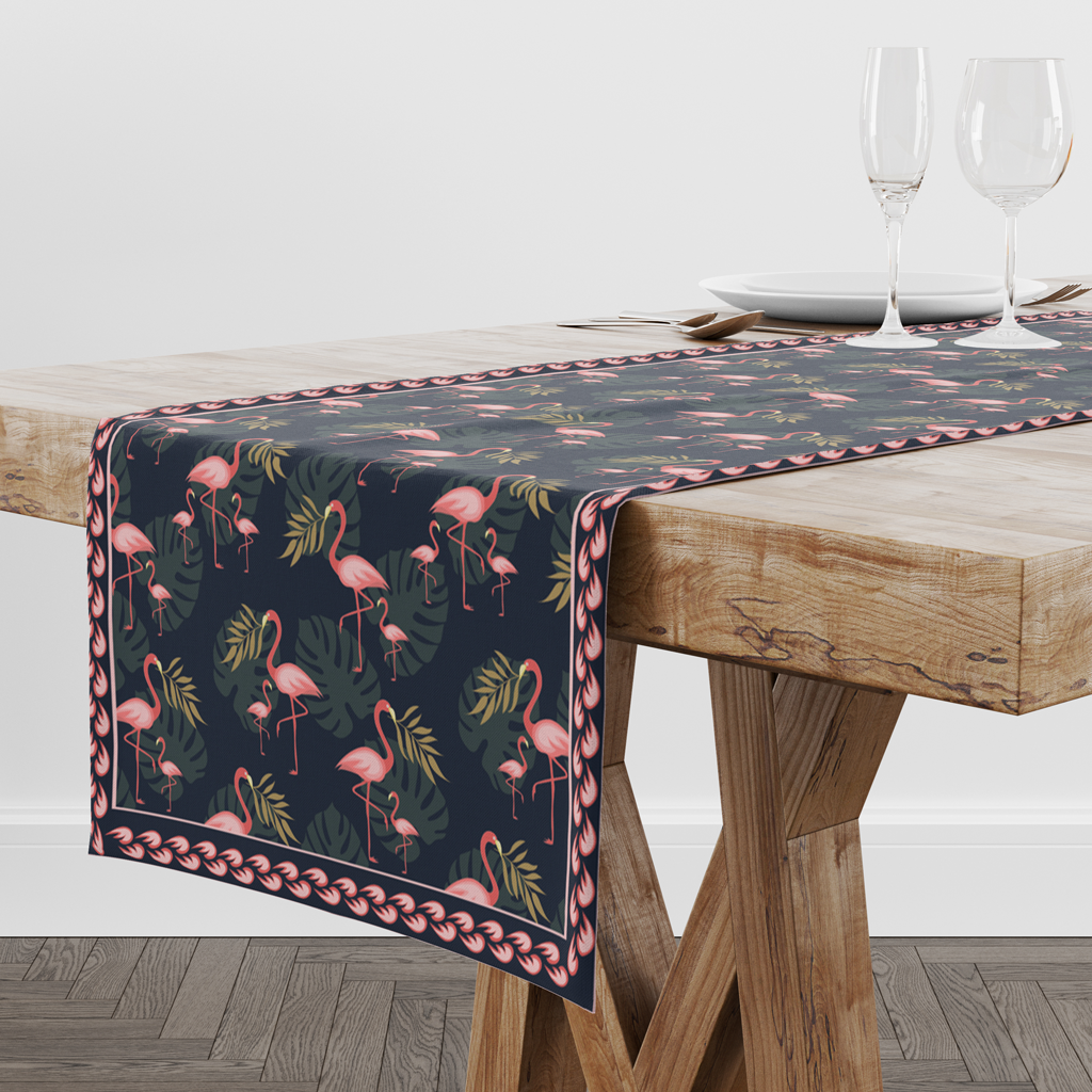 Navy flamingo print table runner on a wooden trestle table with wine glasses