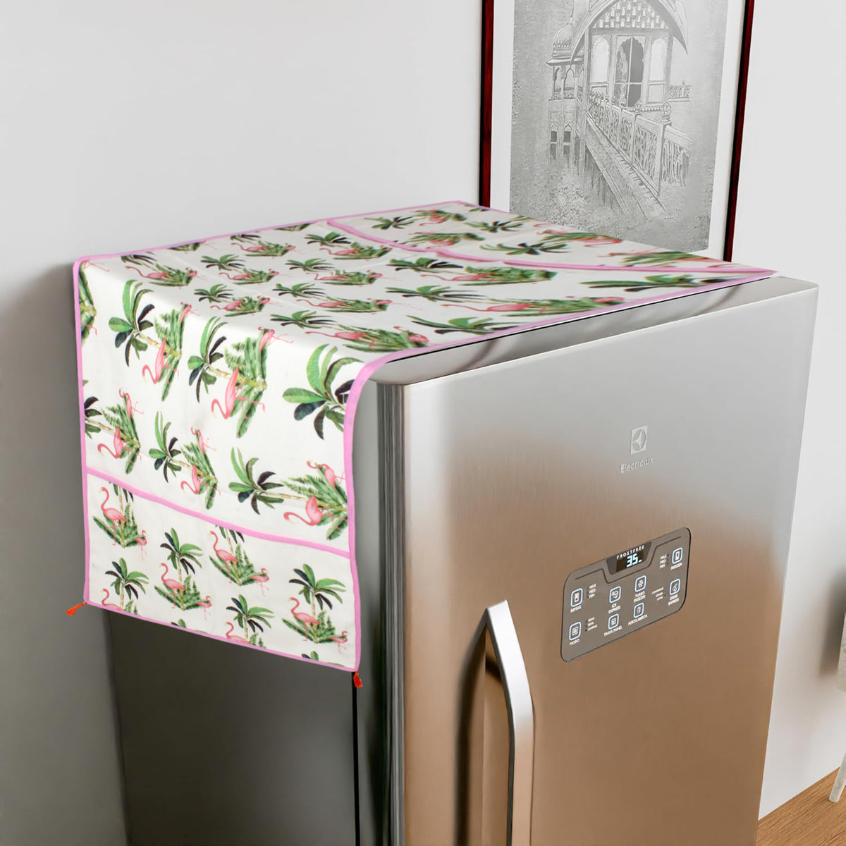 Pink flamingo and palm leaf print fridge cover draped over a single-door refrigerator at an angle