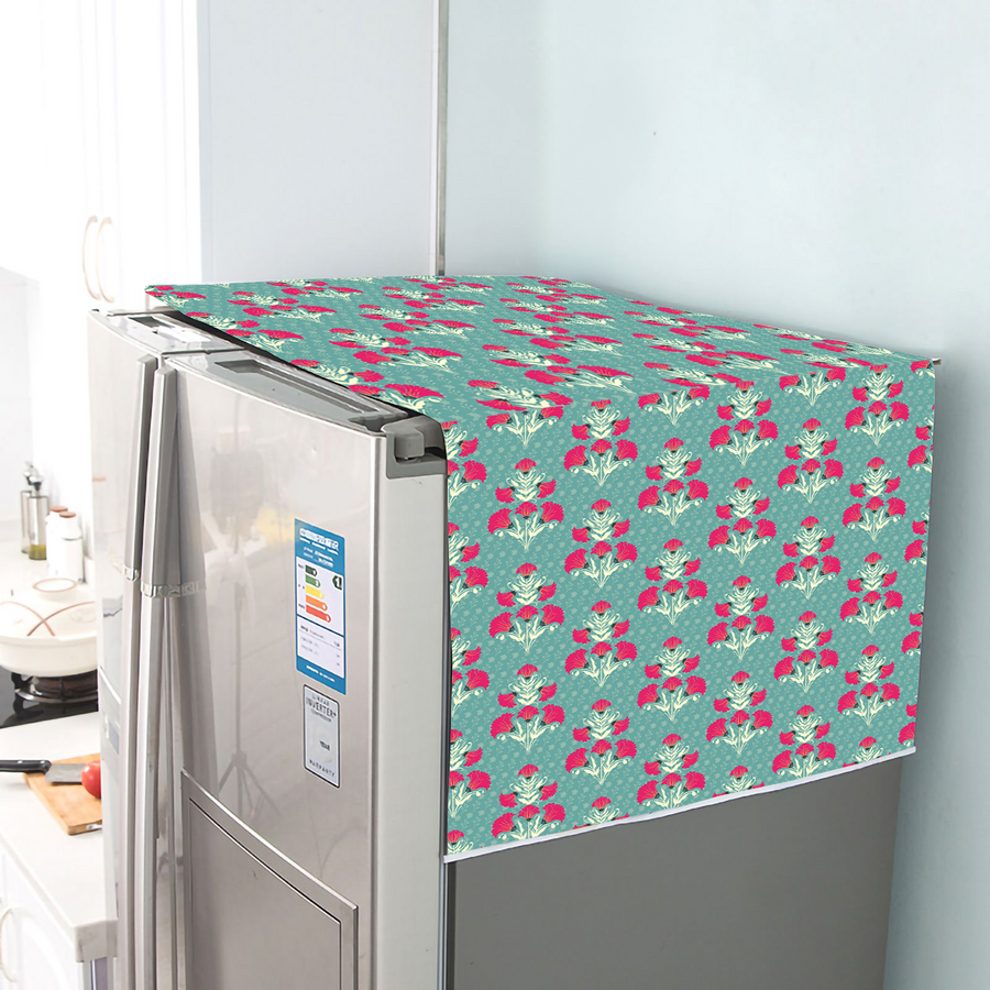 Cotton fridge cover with a red and pink floral print on a teal dotted ground, draped over a refrigerator