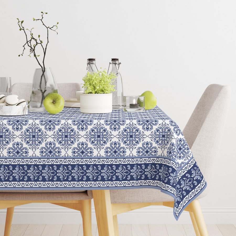 White rectangular tablecloth with blue Turkish tile print, styled on a dining table