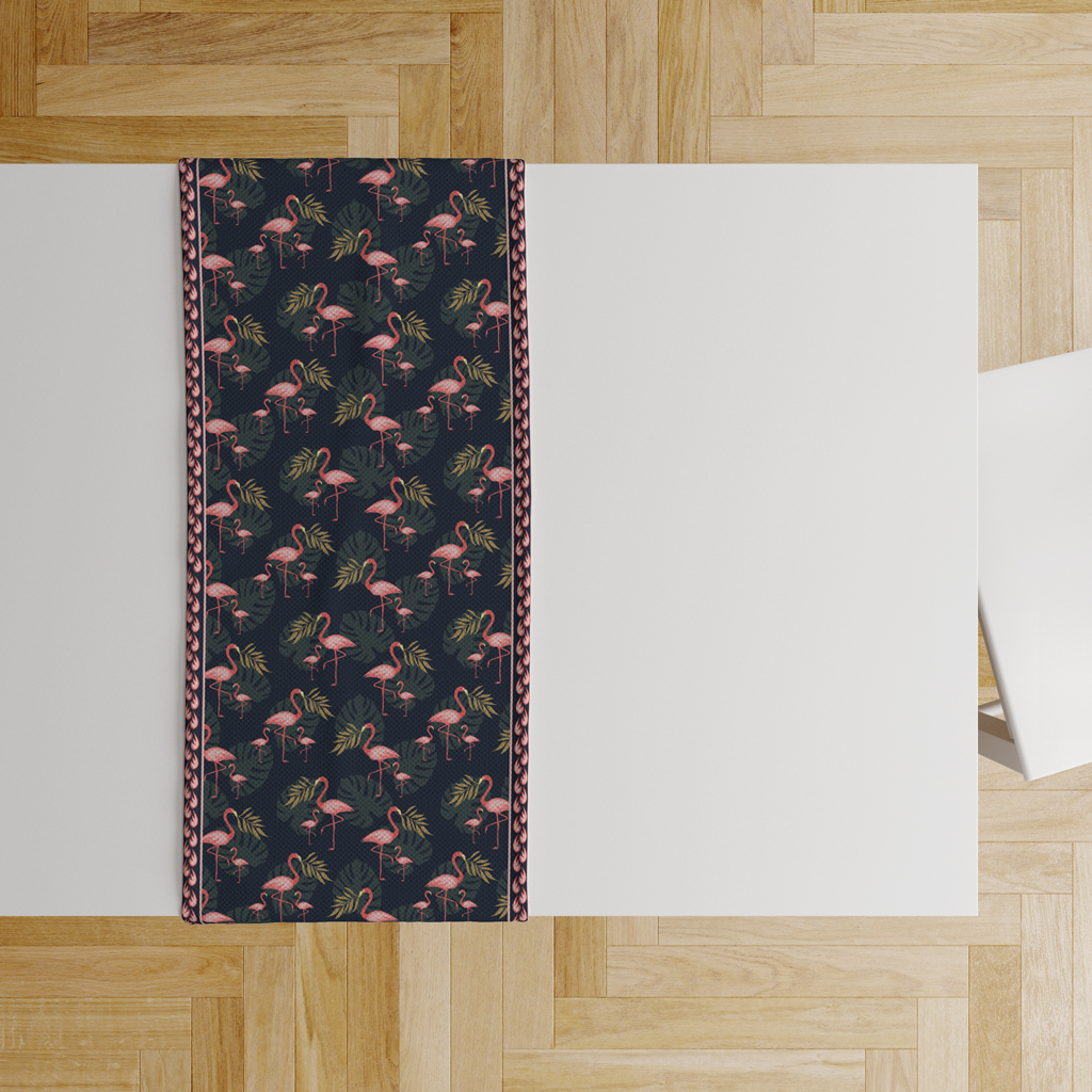 Overhead flat lay of navy flamingo print table runner with place settings